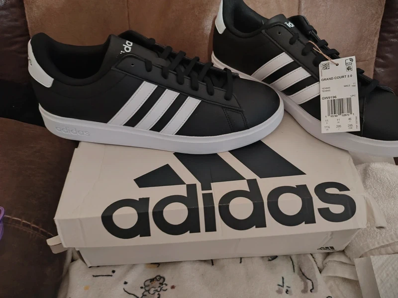 Adidas black and white tennis shoes with cushioning